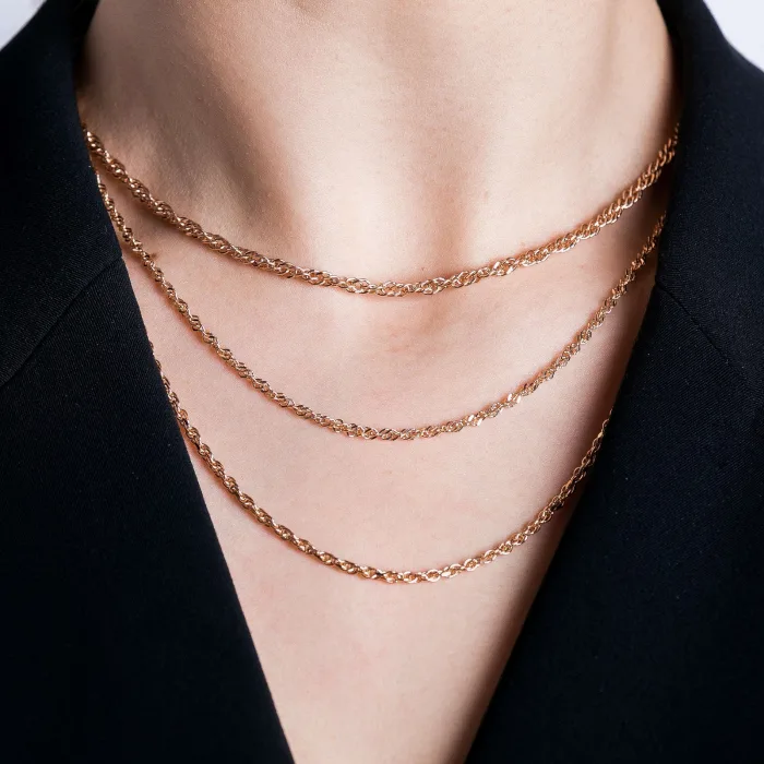 Three rose gold chains worn together